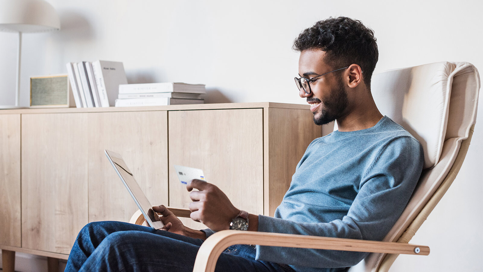 man holding tablet and card